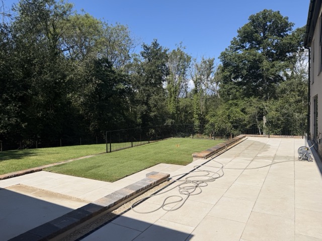 Adding the finishing touches to Plot 12's garden - lots of watering of the turf