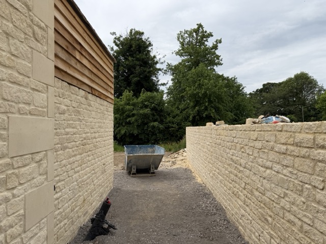 Very long (and expensive) Cotswold stone wall dividing 2 East Gate from the Gallery