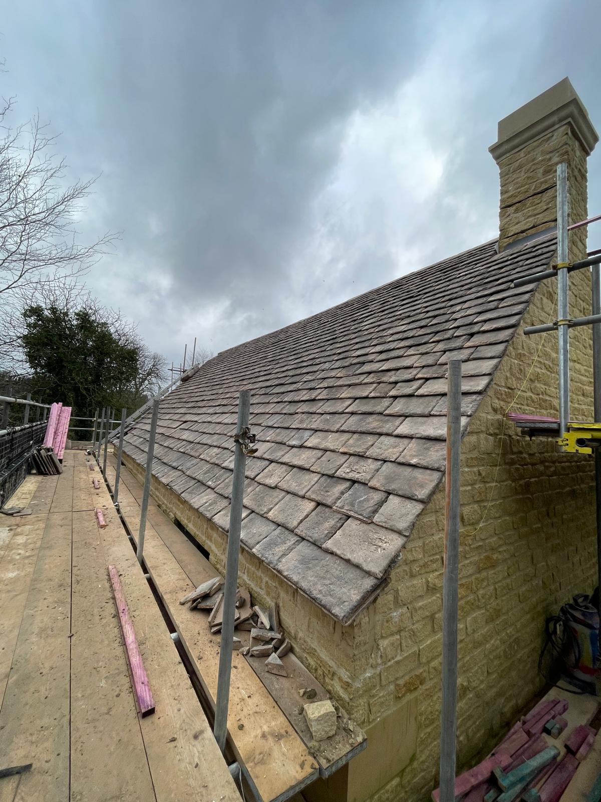 Traditional diminishing course of Cotswold slate going on to the roof which sits on top of Cotswold stone walls
